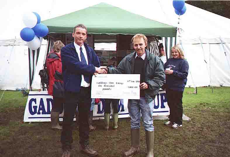 Peter Rigg presents a cheque for 1,000 to the Gaddings Dam Group